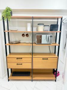 a closet with wooden shelves and a microwave at Centro de Vitoria in Vitória