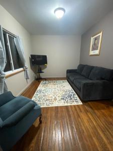 a living room with a couch and a television at The Hideaway in Cleveland