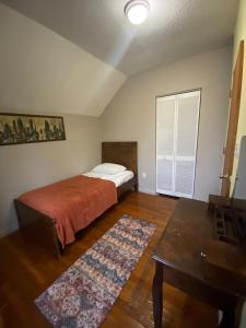 a bedroom with a bed and a table in it at The Hideaway in Cleveland
