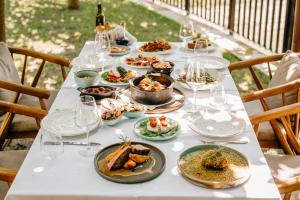 a long table with plates of food on it at la Réserve by Duka Winery in Draç