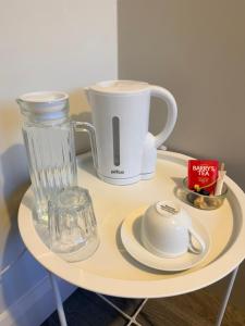 a small white table with a blender and a cup at The Dene Homestay in Drogheda