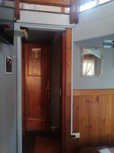 a room with a door and a window and a mirror at Habitación tu Refugio in Isla Negra