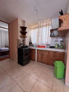 a kitchen with a stove and a counter top at Minidpto Wayra Huanchaco in Huanchaco