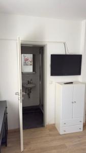 a room with a flat screen tv on a wall at Hotel Alden in Aldenhoven +17 photos