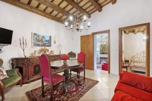 a living room with a dining room table and chairs at Villa Gheta At The Monte Cofano in Custonaci