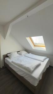 a bed in a room with a window at Hotel Alden in Aldenhoven