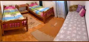 a living room with two beds and a rug at Kuca za odmor Zicanka in Kraljevo
