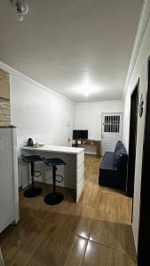 a living room with a desk and a couch at Flat Maracarib um espaço todo seu próximo de tudo in Maragogi