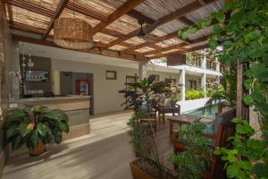 an indoor patio with plants and a bar at Terra Bella Pousada in Morro de São Paulo