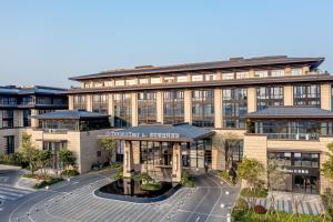 an office building with a street in front of it at DoubleTree By Hilton Cangnan in Hengpu