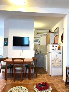 a kitchen and dining room with a table and a refrigerator at Mika Studio in Tivat