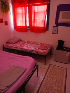 a room with two beds and red windows at Boa Viagem Inn Pousada in Recife