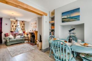 a living room with a table and a couch at 2 Bed in Heacham oc-p29546 in Heacham
