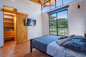 a bedroom with a bed and a large window at Casa Campestre, la Mesa, Vía San Joaquín in La Mesa +20 photos