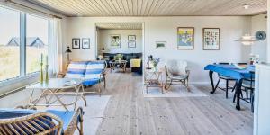a living room with a blue table and chairs at VE072-Vejers-Strand-Violvej-9 in Vejers Strand