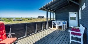 a wooden deck with a table and chairs on it at VE072-Vejers-Strand-Violvej-9 in Vejers Strand +26 photos
