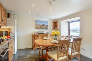 a kitchen with a wooden table and a dining room at 2 Bed in Lairg oc-75909 in Badcall