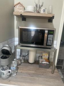 a microwave on a stand in a kitchen at The Casita at Riverwalk in Bakersfield +18 photos