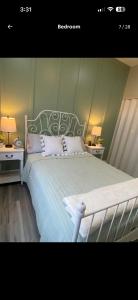 a bedroom with a white bed with two night stands at The Casita at Riverwalk in Bakersfield