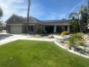 a house with a green lawn in front of it at The Casita at Riverwalk in Bakersfield