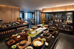 a buffet line in a restaurant with food on display at DoubleTree by Hilton Kyoto Station in Kyoto