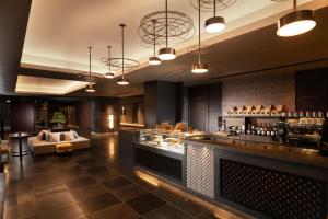 a lobby of a hotel with a bar and a couch at DoubleTree by Hilton Kyoto Station in Kyoto +73 photos