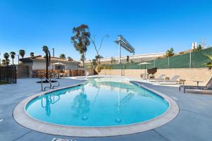 a swimming pool with blue water at Spark By Hilton Redlands in Redlands