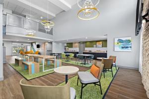 an office lobby with tables and chairs and a cafeteria at Spark By Hilton Redlands in Redlands