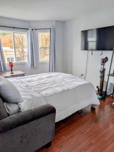 a bedroom with a large bed and a couch at Executive Suite 2 Bedroom Serviced Apartment in Alert Bay