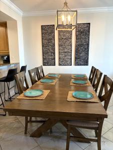 a wooden table with chairs and a dining room at 3BR Beachfront Huge Balcony 2 Pools Luxury in Fort Walton Beach