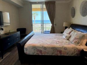a bedroom with a bed with a view of the ocean at 3BR Beachfront Huge Balcony 2 Pools Luxury in Fort Walton Beach +44 photos