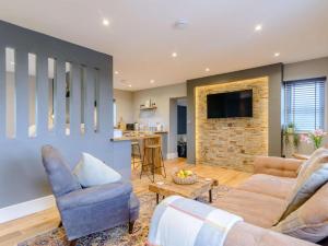 a living room with two couches and a kitchen at 1 Bed in Colne oc-86513 in Rawdon