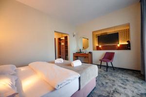 a hotel room with two beds and a mirror at Hotel Ryon Mamaia-Nord in Mamaia Sat/Năvodari