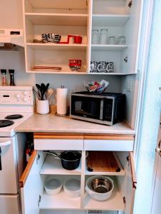 a kitchen with a microwave on a counter at Executive Suite 2 Bedroom Serviced Apartment in Alert Bay +34 photos
