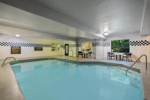 a pool at a hotel with tables and chairs at The Newberry Hotel Bend, Tapestry Collection by Hilton in Bend