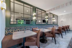 a row of tables and chairs in a restaurant at The Newberry Hotel Bend, Tapestry Collection by Hilton in Bend