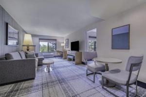 a living room with a couch and a table and chairs at The Newberry Hotel Bend, Tapestry Collection by Hilton in Bend