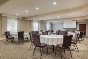 a conference room with tables and chairs and a screen at The Newberry Hotel Bend, Tapestry Collection by Hilton in Bend +131 photos