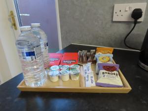 a wooden tray with a bottle of water and some food at Portman House in Middlesbrough +2 photos