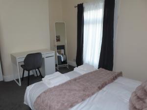 a bedroom with a bed and a desk and a desk at Portman House in Middlesbrough