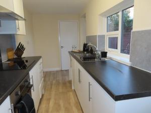 a kitchen with a black counter top and a sink at Portman House in Middlesbrough
