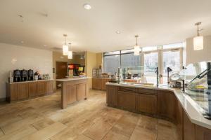 a large kitchen with wooden cabinets and a large window at Staybridge Suites Denver Downtown by IHG in Denver