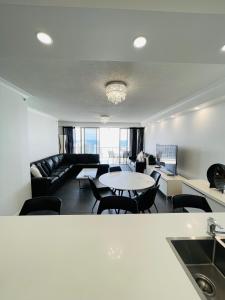 a living room with a couch and a table at Deluxe Chevron Renaissance in Gold Coast +199 photos