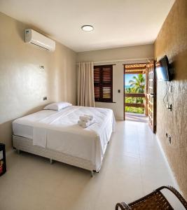 a bedroom with a bed and a television in it at Pousada Hope Club in Beberibe +76 photos
