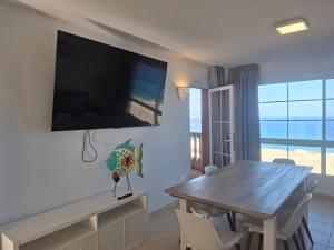 a dining room with a table and a view of the ocean at Paraíso Jandia beach in Costa Calma