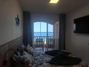 a bedroom with a bed and a view of a balcony at Paraíso Jandia beach in Costa Calma +23 photos