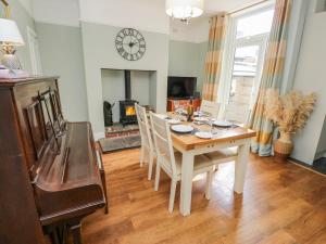 a dining room with a table and chairs and a fireplace at 49 Waddington Road in Clitheroe