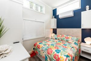 a small bedroom with a bed and windows at Near Beach • Pool + Amenities • Sleeps 8 in Swain +51 photos