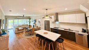 a kitchen with a table and a living room at Galley Cove House in Geographe