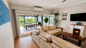 a living room with a couch and a fireplace at Galley Cove House in Geographe